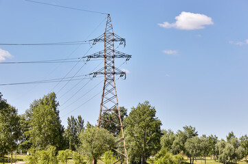 Obraz premium The large high-voltage transmission towers. Steel power pylon construction with high voltage cables on sky background