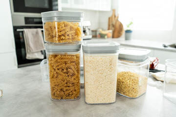 Plastic containers with various food types are on a table.On the table, there are several plastic...