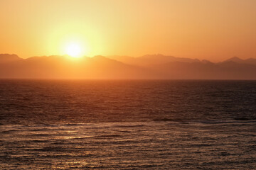 Sunrise above Red Sea and Saudi Arabia mountains. View from Dahab, Egypt.
