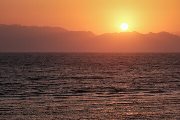 Sunrise over Saudi Arabia mountains and Red Sea. View from Dahab, Egypt.