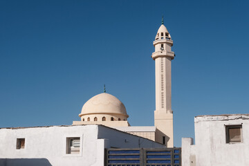 Fototapeta premium View of a mosque on the background of a bkue sky. Dahab, Egypt.