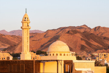 Sunrise view of a mosque on the background of mountains. Dahab, Egypt.
