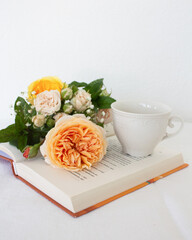 a beautiful arrangement of a bouquet of roses and a book