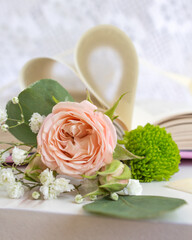 a beautiful arrangement of a bouquet of roses and a book