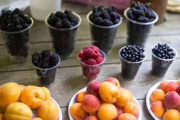 fresh fruits of peaches and raspberries on the counter in summer
