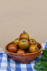 Vertical picture of rustic still life of fresh veggies from the garden. Ceramic vintage bowl with...