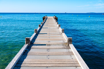 Fototapeta premium Morning view on crystal clear blue water of Plage du Debarquement white sandy beach near Cavalaire-sur-Mer and La Croix-Valmer, summer vacation on French Riviera, Var, France