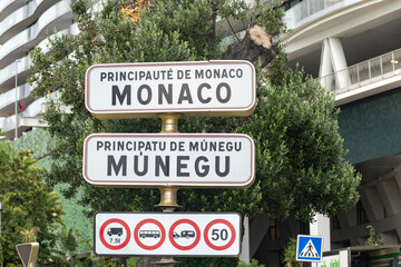 Driving car on French Riviera, road signes with directions to Monaco, english translation of board:...