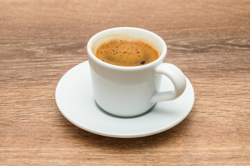Turkish coffee in modern coffee cup on wooden table