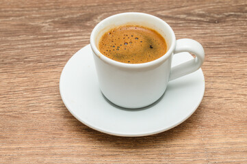Food background with cup of coffee and cezve on wooden table