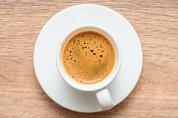 Traditional Turkish coffee in traditional silver cup on wooden table , top view,