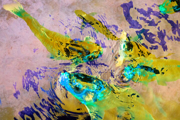 Colorful paint splashing on the surface of the water. Abstract background