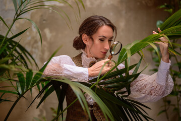 beautiful woman scientist in retro style with magnifying glass