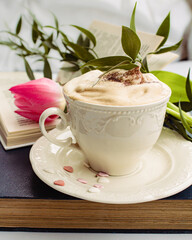 a beautiful arrangement of a bouquet of tulips and a book with a cup of coffee