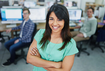 Fototapeta premium Portrait, arms crossed and woman in office, business and proud with smile, coworking and internship. Creative, graphic designer and opportunity in agency, happy and confidence of person in startup