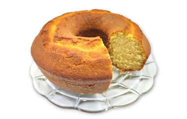 Photo of a traditional rounded delicious vanilla pound cake, isolated on white background.