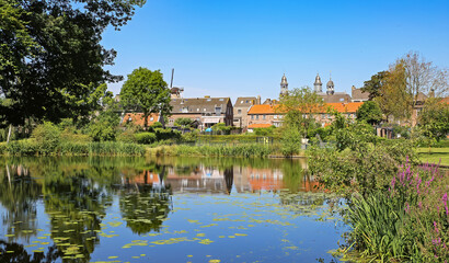 Beautiful idyllic lake with windmill background in old countryside town - Ravenstein, Netherlands, Noord-Brabant