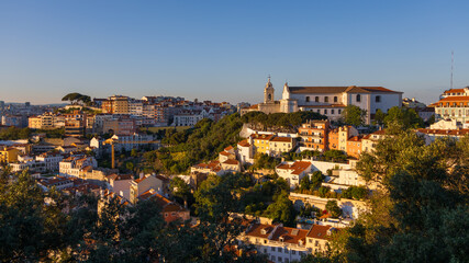 Aerial view of Lisbon cityscape, budlings with red roofs in Portugal, during sunset, the...