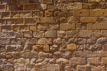 Rugged Stone Wall In Barcelona With Rich Textures
