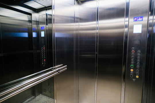 Gray metal elevator with a mirror in front of the door