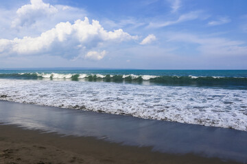 beautiful landscape on the coast of the beach and sea waves against the background of the blue sky