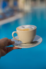 a cup of fragrant coffee in a restaurant brought by the waiter