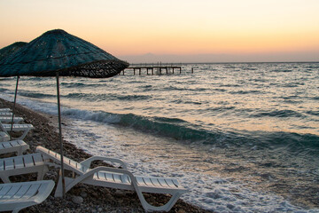 deck chairs and umbrellas on the sea beach in summer