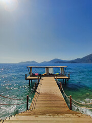 Naklejka premium beautiful bungalows for relaxation in the middle of the water with a path from the beach