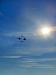 a beautiful air show of fighter jets in the sky over the sea