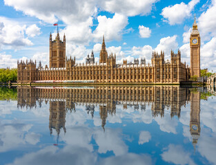 Houses of Parliament and Big Ben tower reflected in Thames river, London, UK