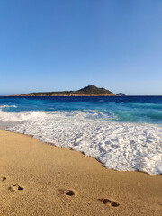 landscape with human footprints on a sandy sea beach