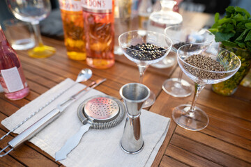 many different ingredients on the bartender's table for making alcoholic cocktails