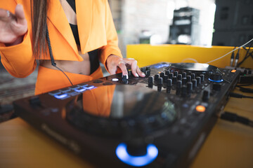 a DJ plays music on a controller at a party