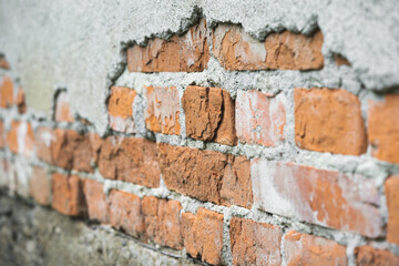 texture of old cracked brick wall and peeling plaster