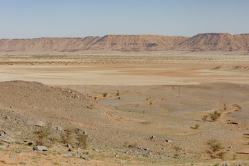  Merzouga, Morocco, features towering sand dunes, mesmerizing sunsets, and serene camel treks. Acacia trees dot the landscape, adding a touch of greenery to this enchanting desert adventure