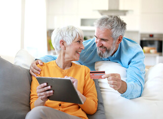 couple credit woman tablet shopping card online senior elderly retirement adult old retired mature...