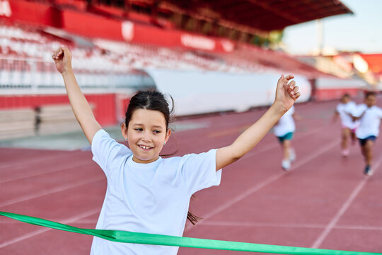 child sport athlete competition running race exercise sprinting speed runner achievement finish line celebration challenge champion goal ribbon success