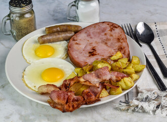 fried eggs  with ham, bacon and sausage