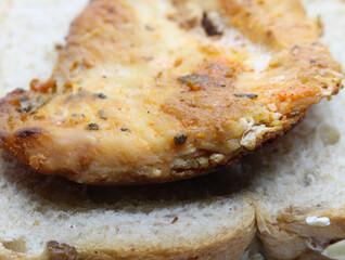 bread with chicken fillet. grilled chicken on wholemeal bread. meal details. food with selective focus.