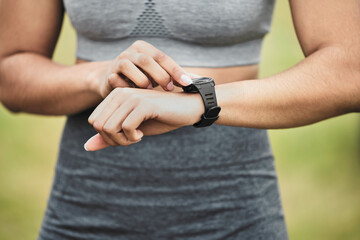 Hands, exercise and smart watch with sports woman outdoor, checking the time during a workout. Arm, fitness and technology with person tracking cardio or endurance performance while training