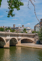 Bridge Pont Neuf and Seine river with old houses in Paris, France. 
