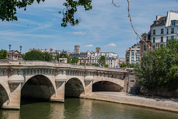 Bridge Pont Neuf and Seine river with old houses in Paris, France. 