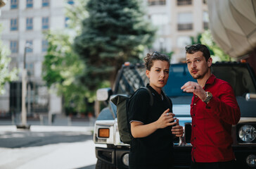 Two individuals in an urban environment engaged in a serious discussion beside a parked vehicle. The mood is intense and focused.