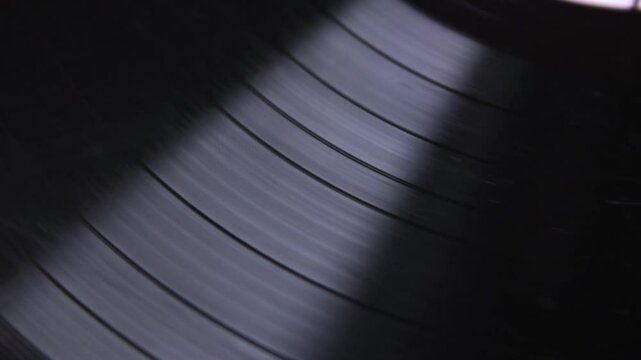 Rotation of broken vinyl disk in player closeup