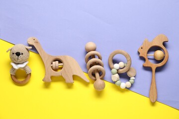Different baby rattles on color background, flat lay