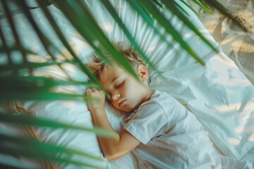 Cozy and peaceful small boy's dreams surely hold wonder. Serenity fills space boy enjoys secure and blissful slumber. Serene setting highlights fundamental human need relaxation and recovery.
