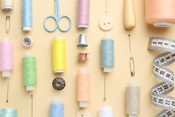 Flat lay composition with different sewing supplies on beige background