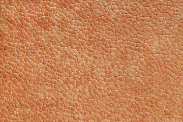 Velours orange fabric with with embossed pattern like leather structure texture close up, macro