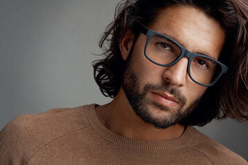 Designer, fashion or portrait of man with glasses, vision or clear sight on grey background in...
