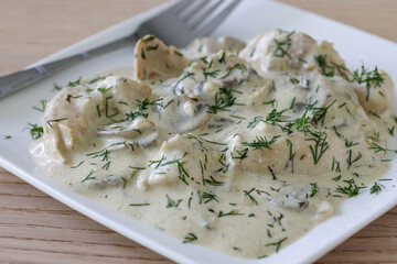 Tender chicken pieces draped in creamy dill sauce